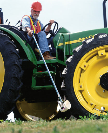 Person on large tractor picking up trash with EZ Reacher