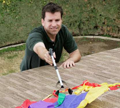 Man grabbing kite from roof with EZ Reacher